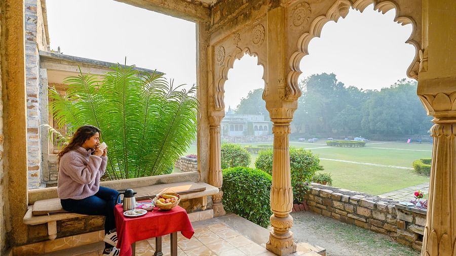 Deo Bagh - 17th Century, Gwalior - a woman sitting at the arch-shaped hallway while enjoying her tea 1