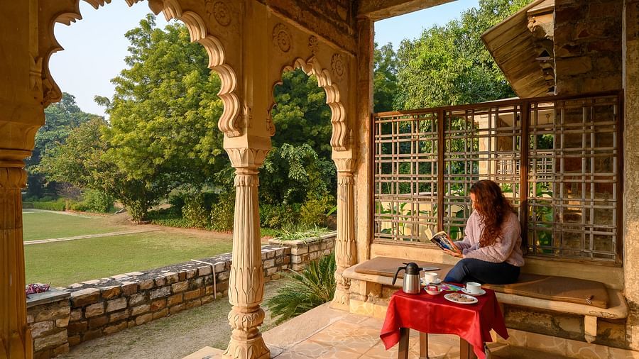 Deo Bagh - 17th Century, Gwalior - a woman sitting at the arch-shaped hallway while enjoying her tea