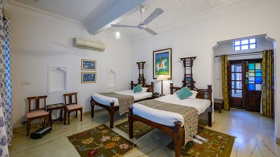 Deo Bagh - 17th Century, Gwalior - twin sharing beds with turquoise pillows on top of it at the Ranjit Raje Mahal - Naubagh / Garden View hotel stay inn Gwalior
