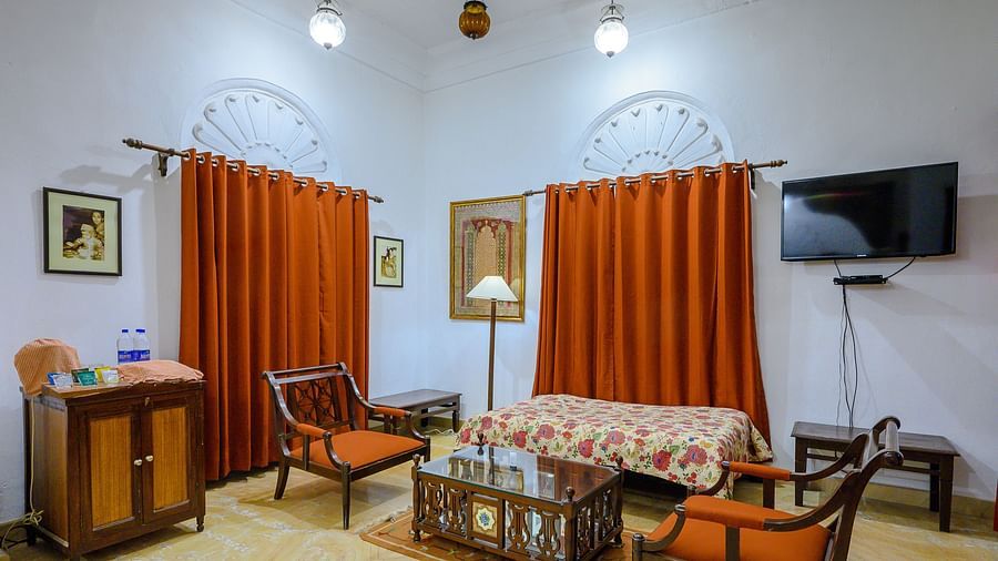 Deo Bagh - 17th Century, Gwalior - the separate seating area with orange curtains hanging behind it at the Rohini Raja Mahal