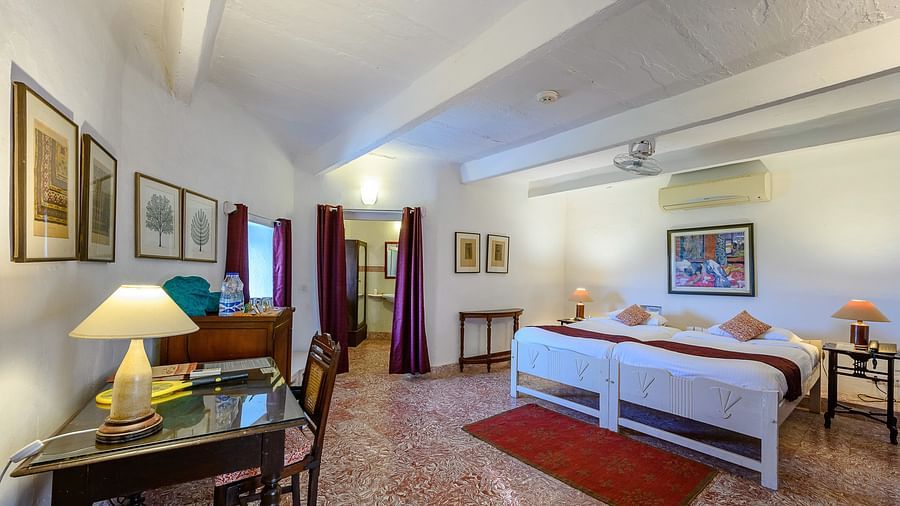 Hill Fort Kesroli 14th Century Alwar - interior view of the Mangal Mahal - Pool View with twin beds, white walls decorated with paintings