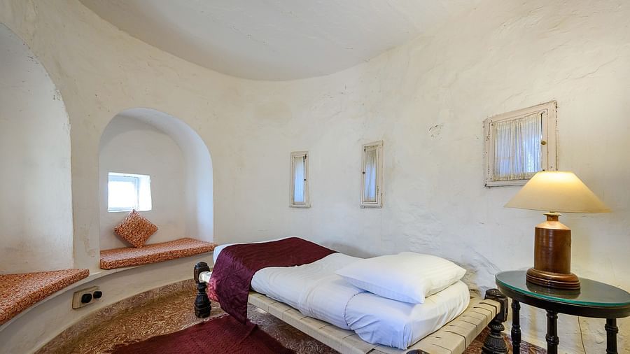 Hill Fort Kesroli 14th Century Alwar - interior view of the Mangal Mahal - Pool View with a single bed, a lamo