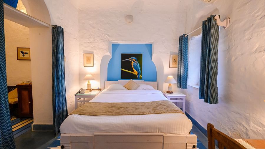 Interior view of the Neelkanth Mahal - Countryside View room with a queen size bed and lamps on either sides