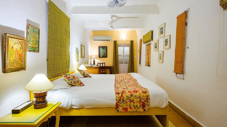 Hill Fort Kesroli 14th Century Alwar - interior view of the Pitambar Mahal with green decor featuring a king size bed