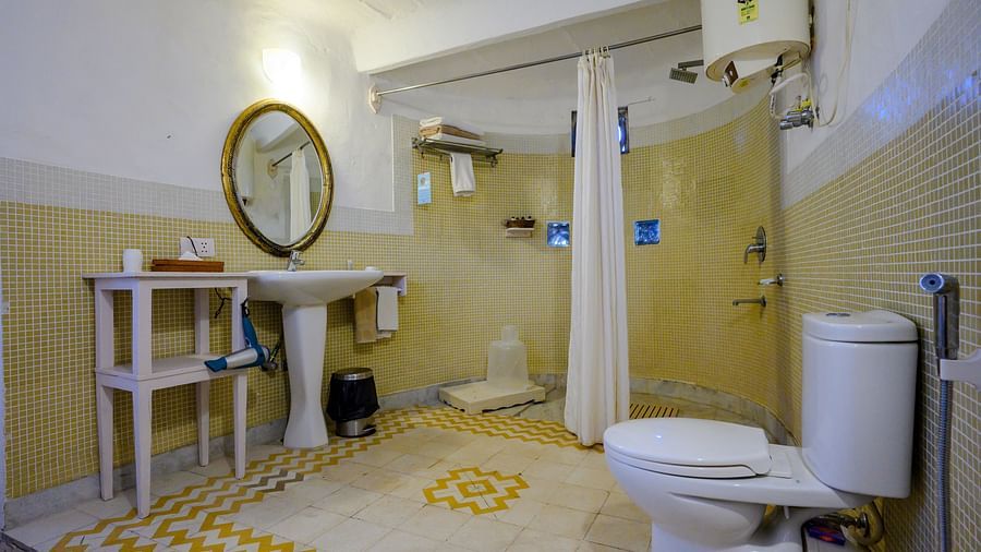 Hill Fort Kesroli 14th Century Alwar - interior view of the Raunak Mahal - Village View Bathroom featuring a commode, shower area, wash basin and a circular mirror