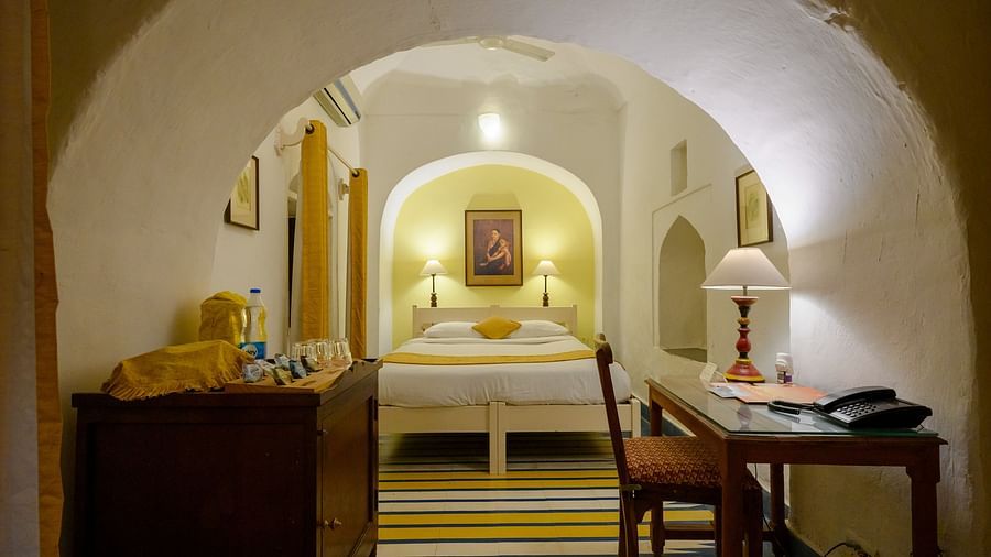 Hill Fort Kesroli 14th Century Alwar - interior view of the Swagat Mahal Room featuring a queen size bed and a work desk with chair