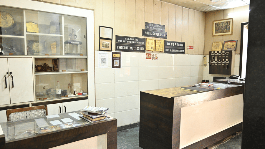 Reception desk with a wall mounted cabinet at Goverdhan Hotel, Agra