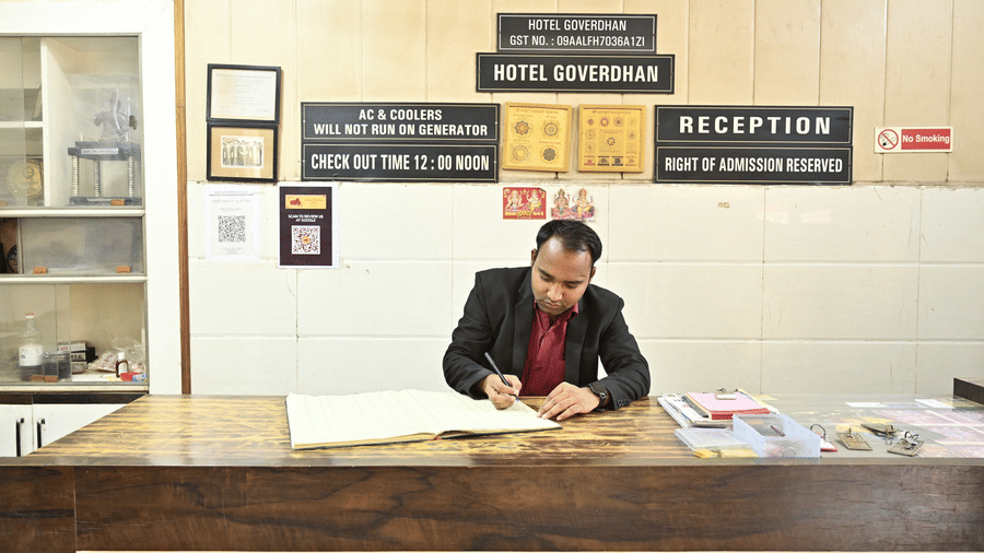 A receptionist at the reception desk of Goverdhan Hotel, Agra