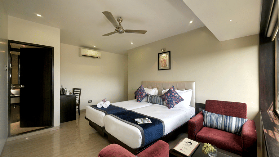 The premium room with bed and cosy sitting area at Hotel Le Grande - Mumbai International Airport.