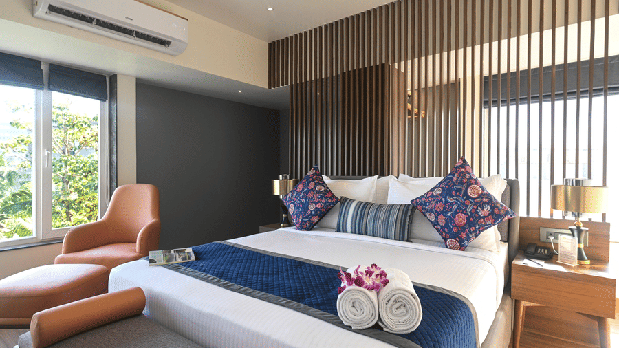 Studio Suite show casing cosy bed and sitting area at Hotel Le Grand.