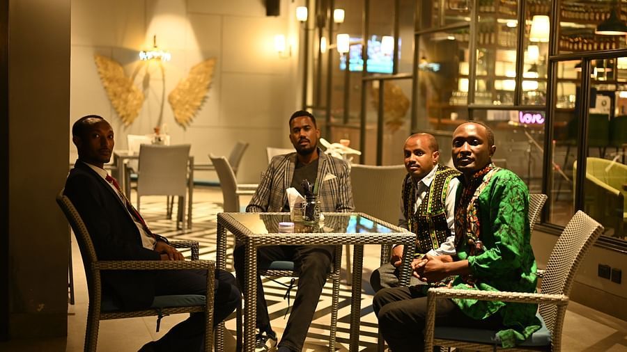 people at a restaurant table posing for a photo - Hotel Polo Towers, Agartala