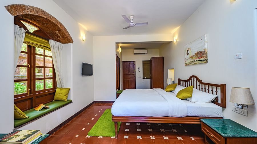 A double bed marble side table wardrobe inside Mitras - River View - River View room at neemrana s three waters