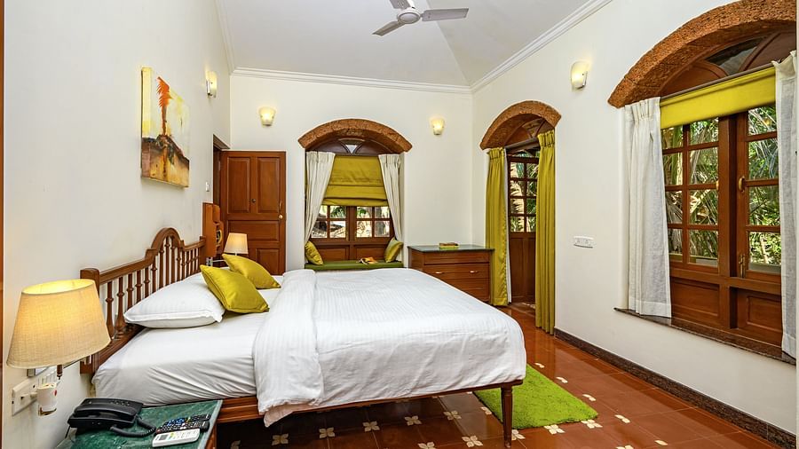 A double bed with marble side table at Babylonia - Cassis - River / Pool View room in Neemrana s Three Waters