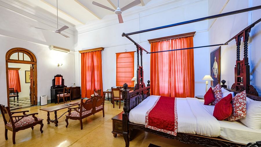 A king size bed with sofas and coffee table in Raja Baba Ala Singh room - The Baradari Palace