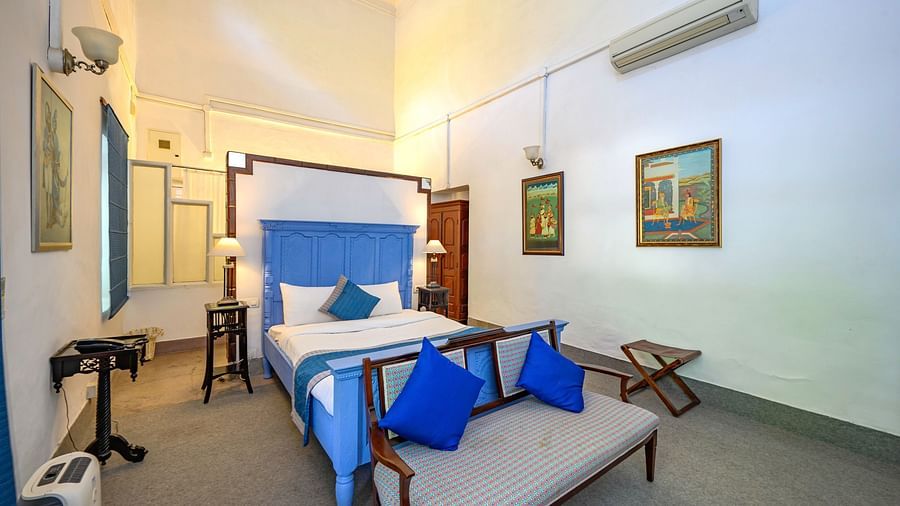 An overview of the Maharani Mohinder Kaur room with a double bed and sofa in front of the bed - The Baradari palace