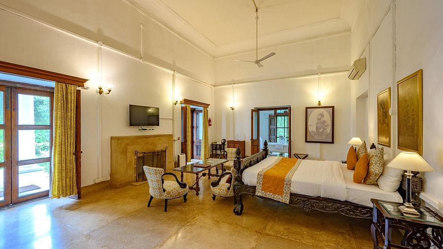 A double bed in front of sofa with coffee table inside Maharaja Sahib Singh room - The Baradari Palace