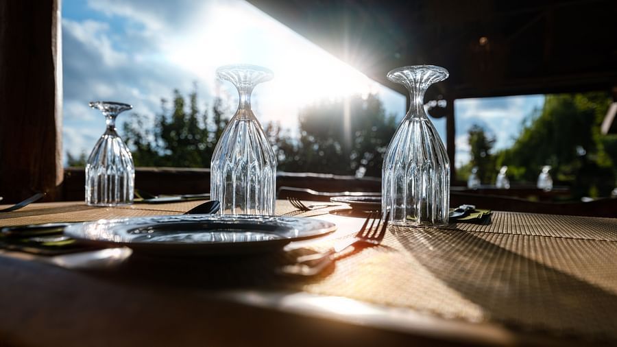 Another angle of dining table with champagne glasses placed upside down on it - The Manor Luxury Hotel, Shimla