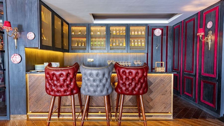 Two red coloured high chairs place in front of a bar counter - The Manor Luxury Hotel, Shimla