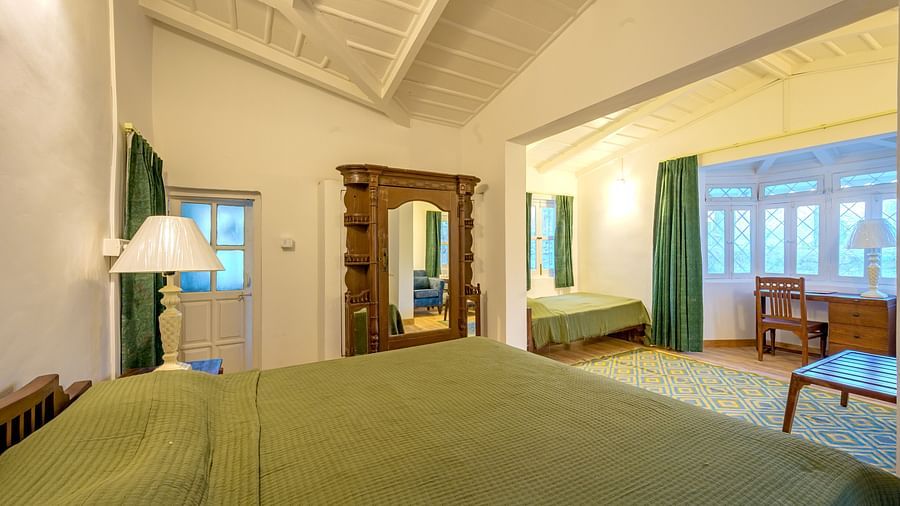A view from the bed of a room with lamps and chairs in view - Ramgarh Bungalows, Nainital.