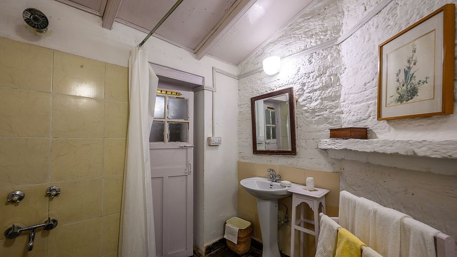 A washroom with towel stand and separate shower space - Ramgarh Bungalows, Nainital.