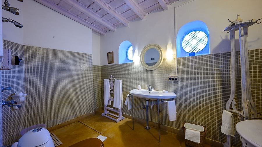 A Washroom of Gaitonde room featuring a bathrobe and bath towel - Ramgarh Bungalows, Nainital.