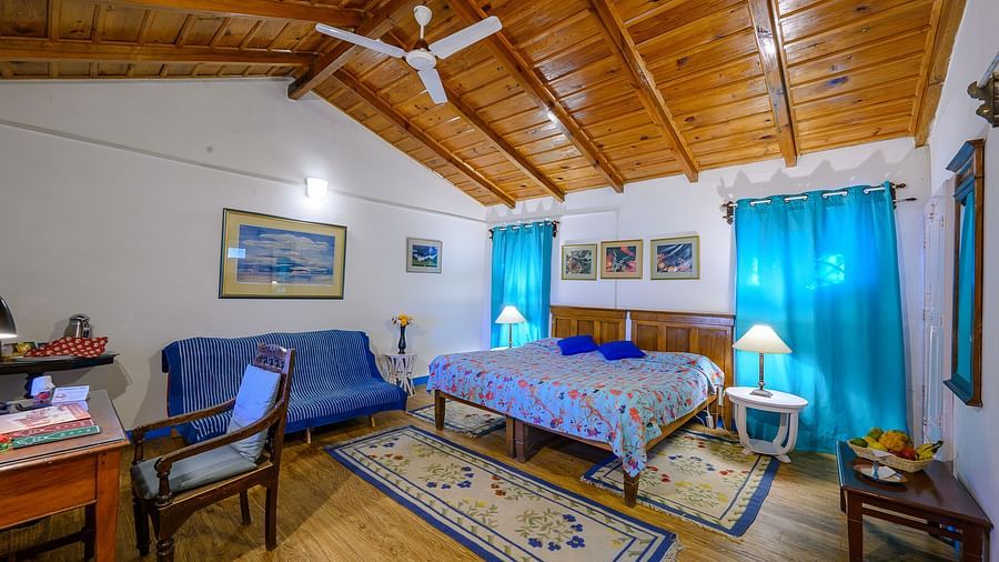 Irish room with wooden interior, a work desk with chair and other room amenities - Ramgarh Bungalows, Nainital.