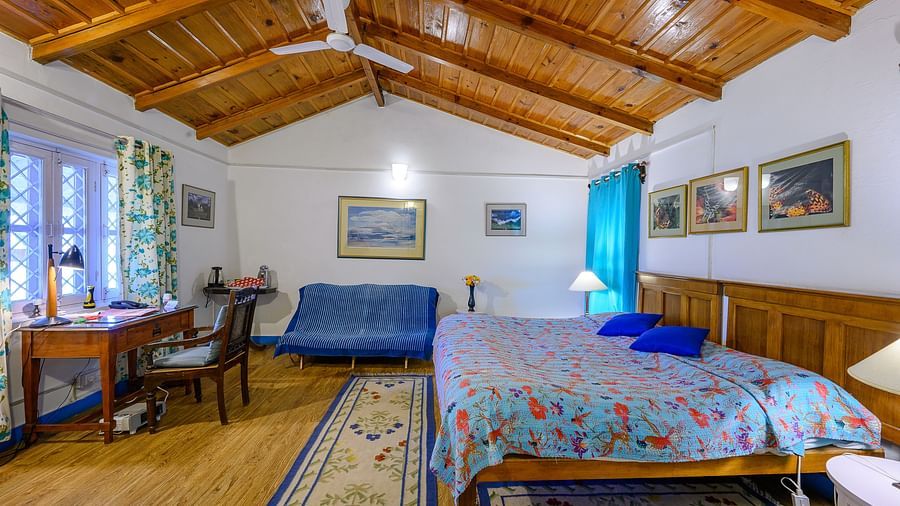 Irish bedroom with double queen size beds, grand wooden interior and a work desk - Ramgarh Bungalows, Nainital.