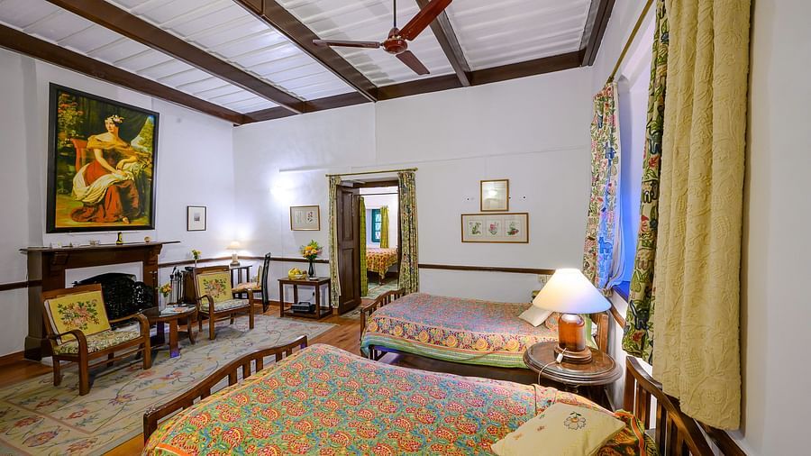 Kashmir room with two queen size beds featuring a bedside lamp and a fireplace - Ramgarh Bungalows, Nainital.
