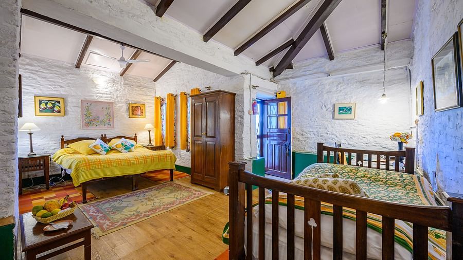 Lemon room with two double beds and room amenities like a wardrobe and a television - Ramgarh Bungalows, Nainital.