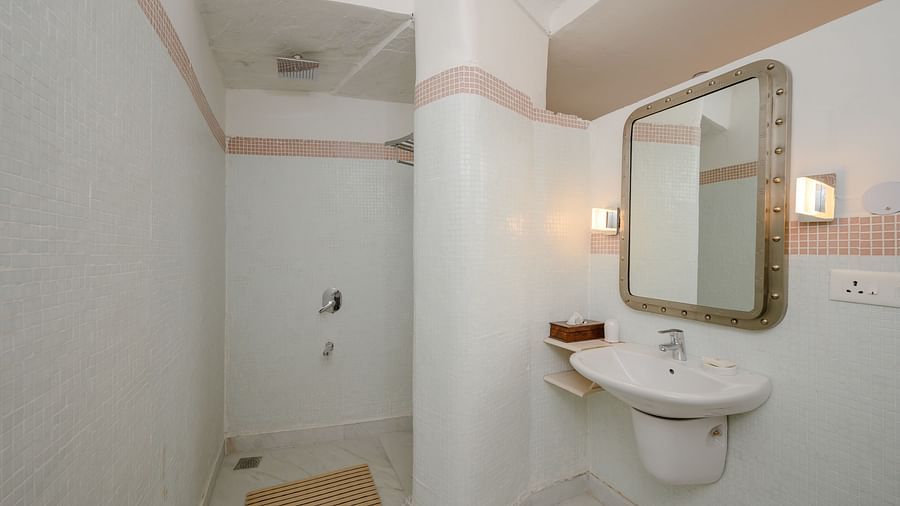 Bathroom with sink, mirror, shower, and outlet - Tijara Fort-Palace - 19th Century, Alwar.