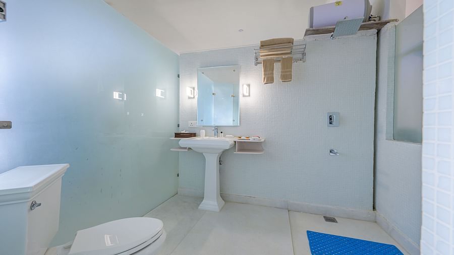 Bathroom with toilet, sink, mirror, shower, and towel rack - Tijara Fort-Palace - 19th Century, Alwar.