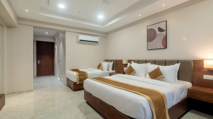 A double and a single bed inside the Super deluxe room - VITS Satyajeet Karad