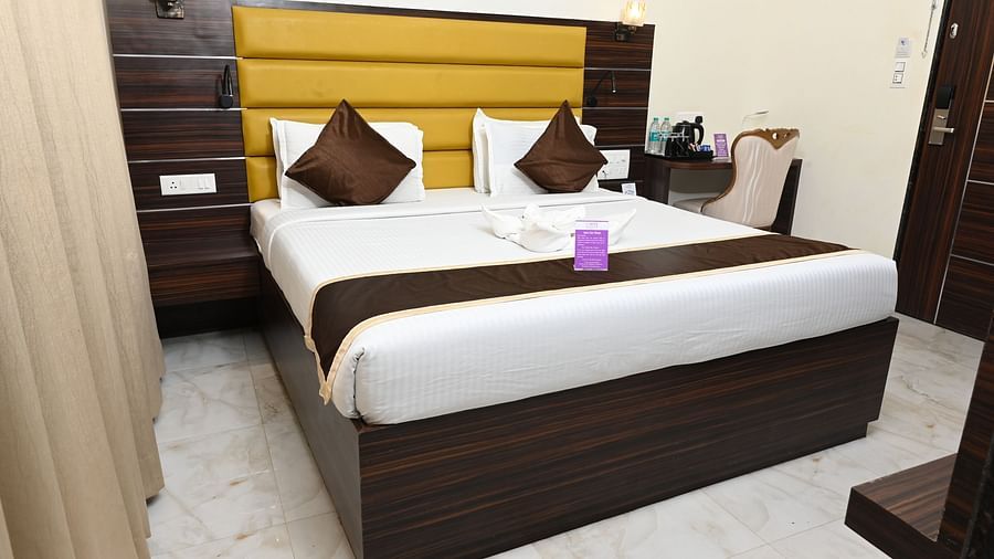 a double bed with a side table on the right inside one of the rooms - VITS shanti solitaire, North Goa