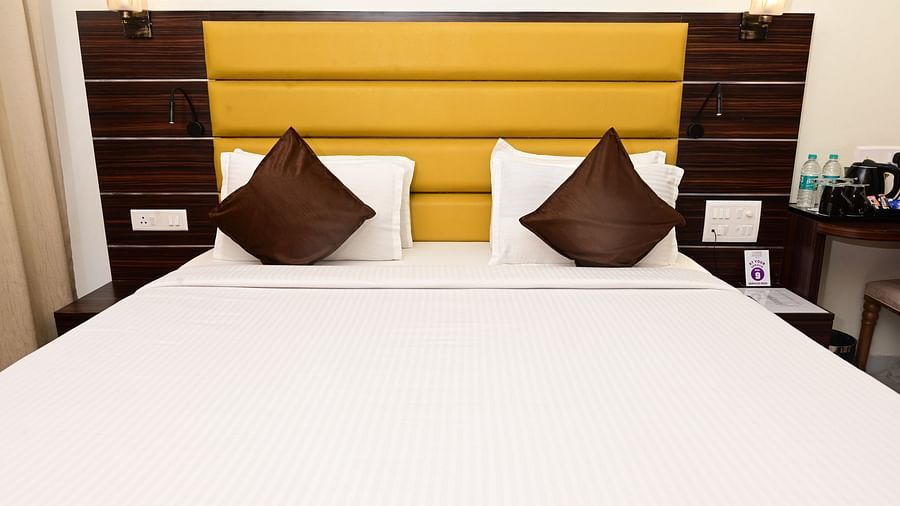 a close up view of the double bed with pillows on top of it inside one of the rooms at VITS shanti solitaire, North Goa