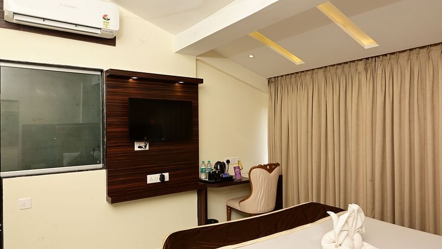 an AC and a TV wall mounted inside a room at VITS shanti solitaire, North Goa