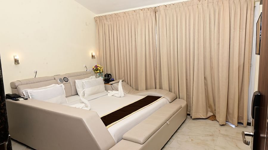 a modern double bed with pillows on top inside one of the rooms - VITS shanti solitaire, North Goa