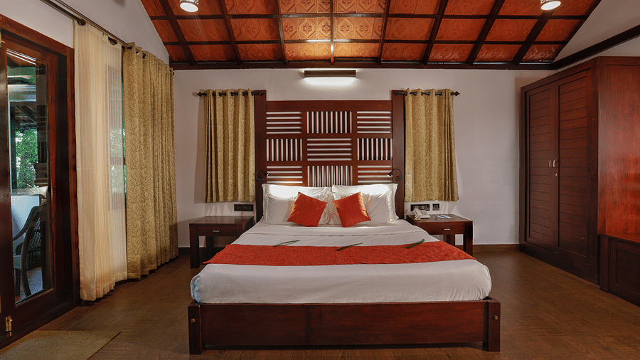 A front view of a bed in a bedroom | Vythiri Resort. Wayanad