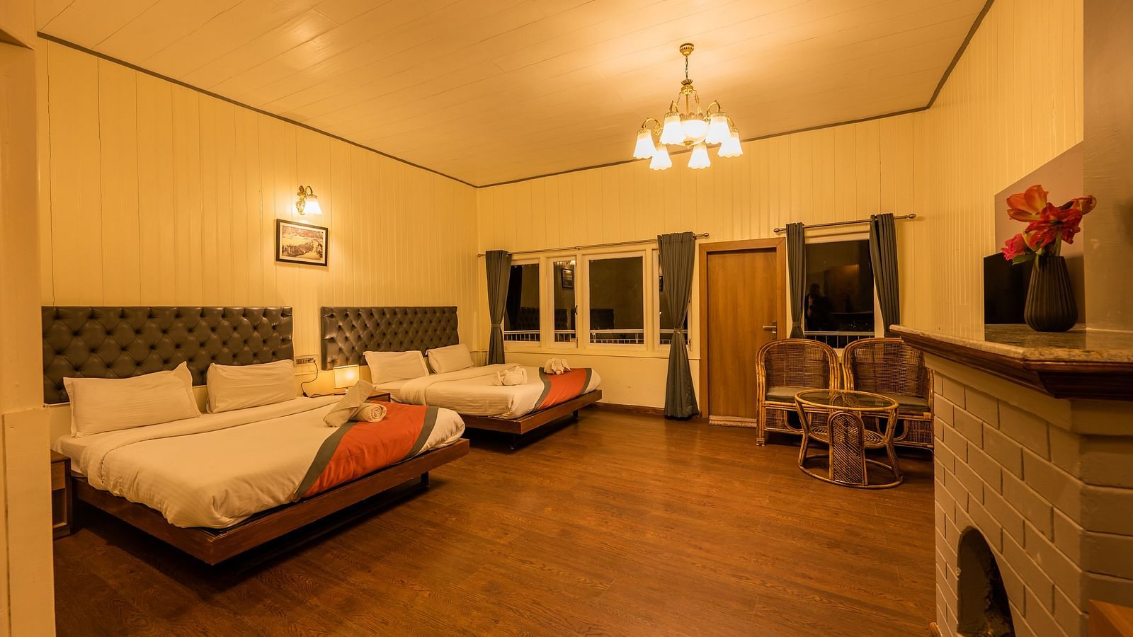 A spacious family room with 2 comfy beds, table, chimney at Arcadia Heritage Resort, Darjeeling