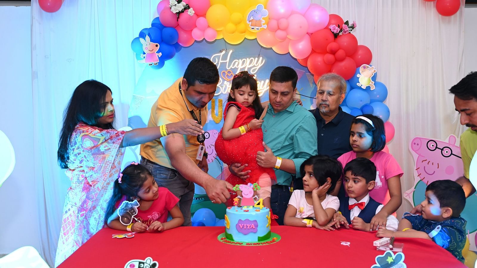Family celebrating a child's birthday party with a colorful cake and decorations |  Diamond Parks, Pune