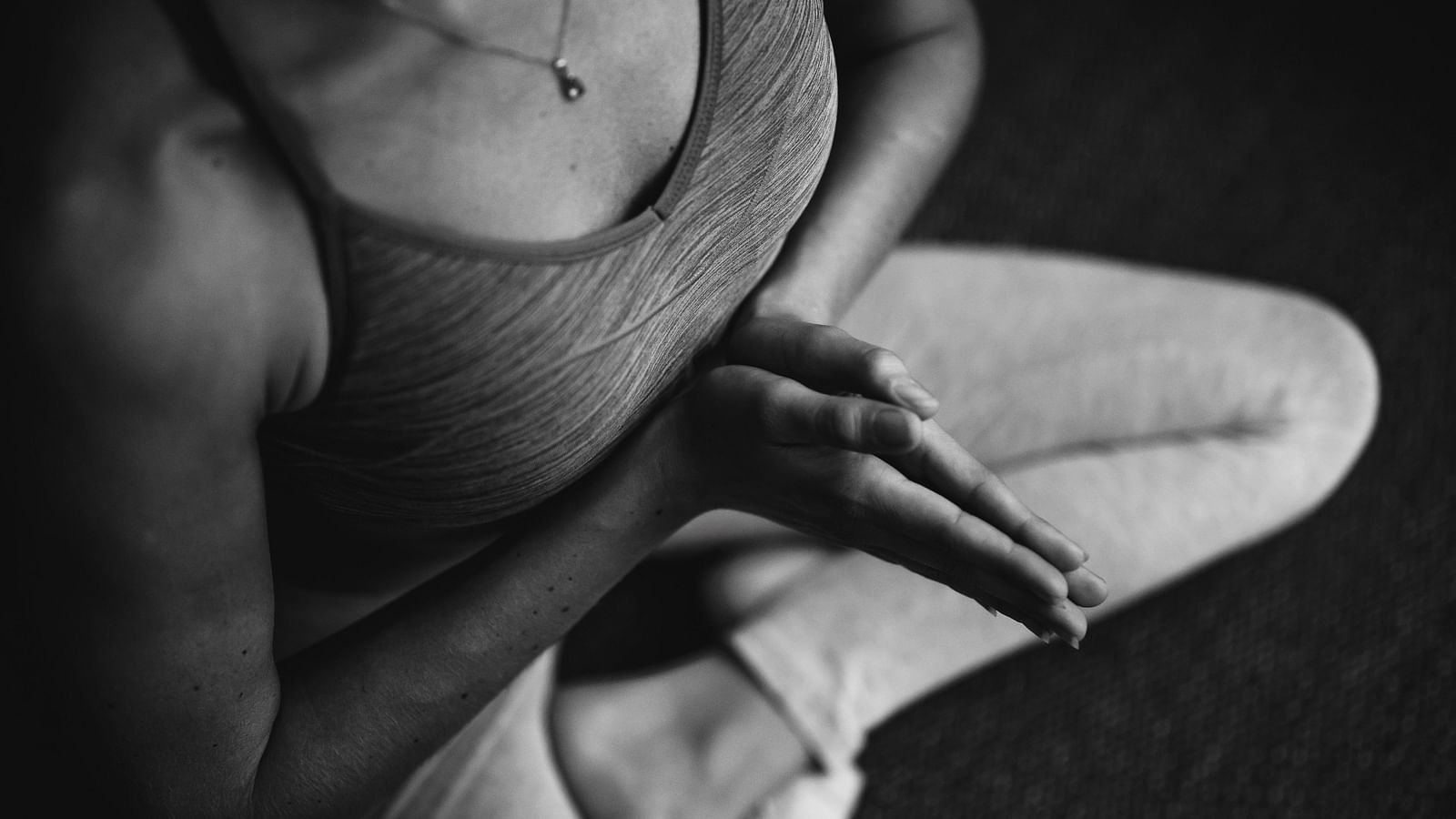 A person sits cross legged on the floor to exercise - Monsoon and ayurveda - Gamyam Retreat