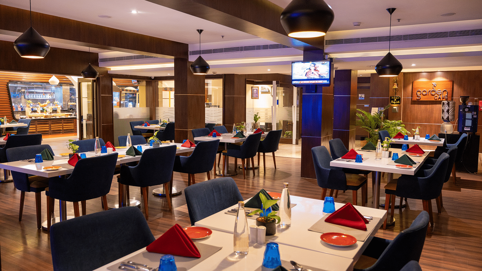 An image of  a dining space with a television  at Grand Kakinada by GRT Hotels