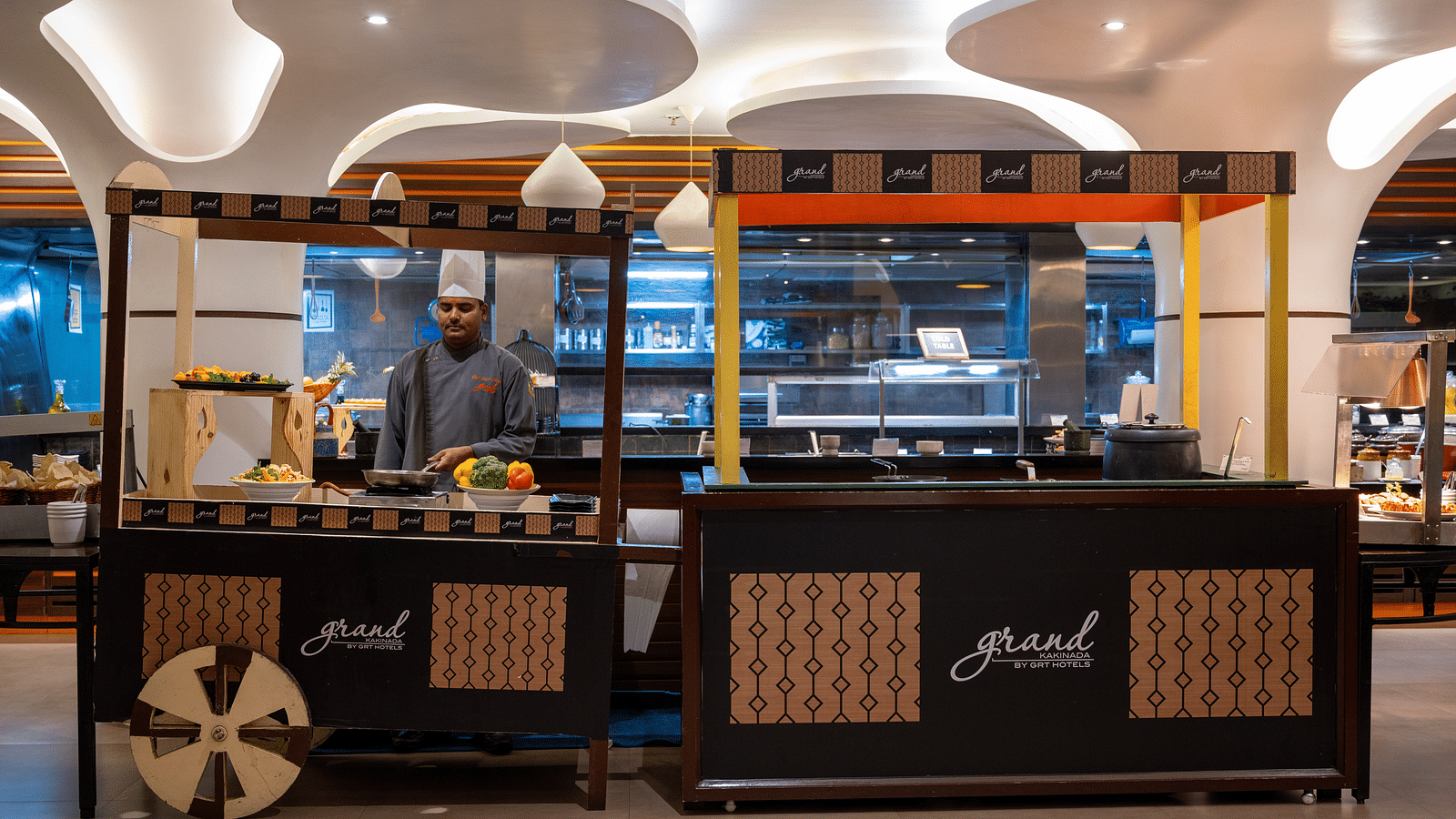 An image of a live kitchen with a chef at Grand Kakinada by GRT Hotels