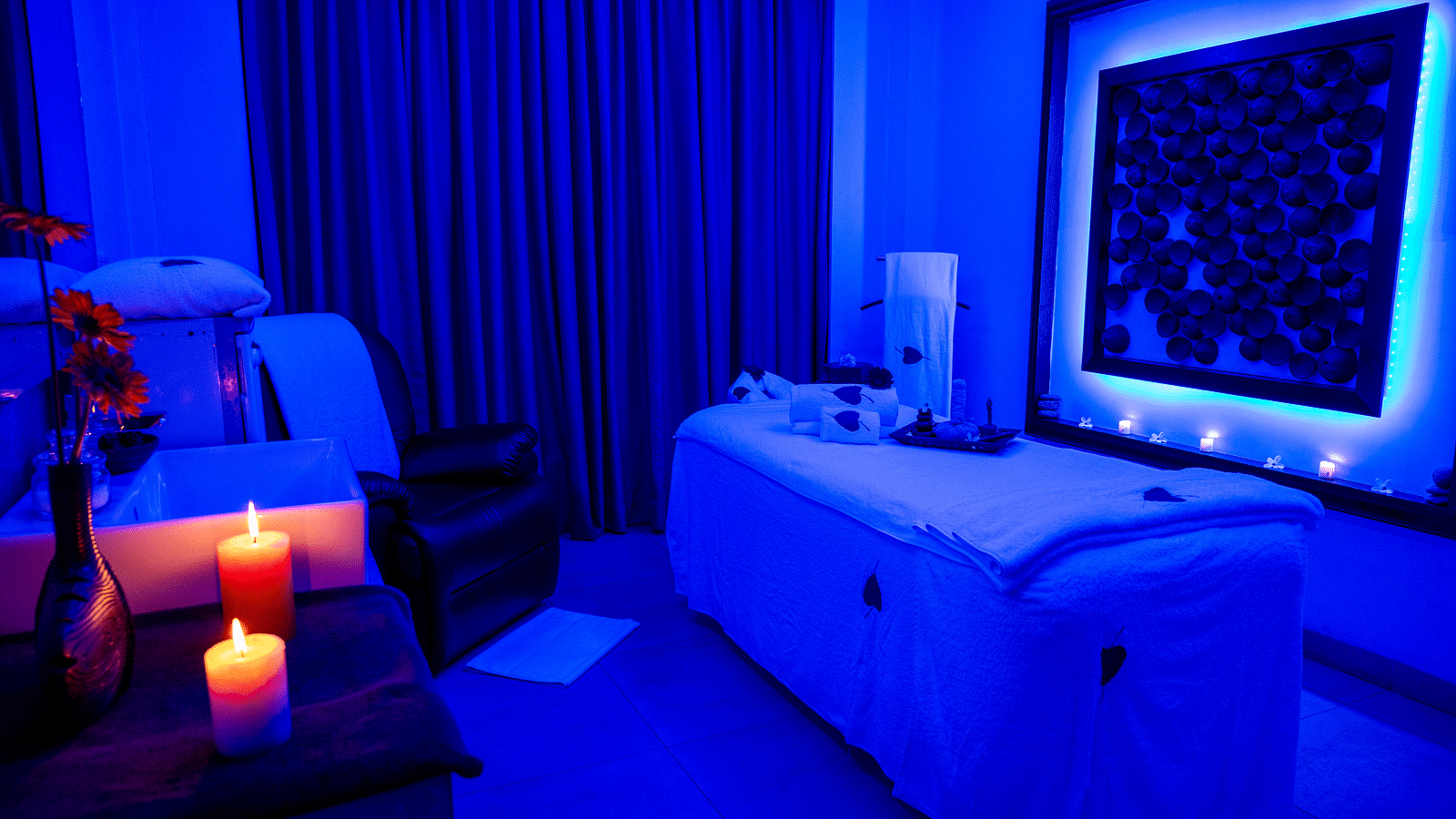 An image of the spa bed filled with spa essentials at image of an event hall with tables and chairs at Grand Kakinada by GRT Hotels
