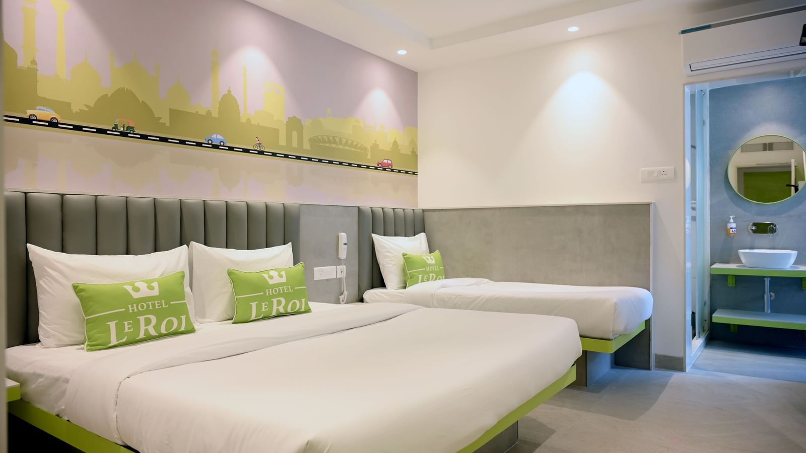 A bedroom featuring double size bed and a single bed. The room also features a bedside table and a bathroom attached.
