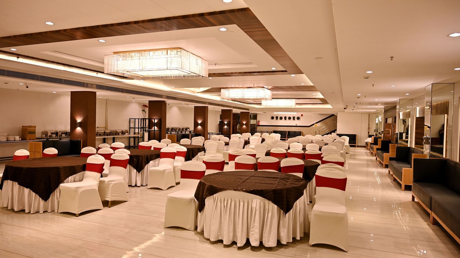 Banquet hall viewed from the end, showcasing the regal chandeliers and polished floors - TGI Insignia, Bhopal