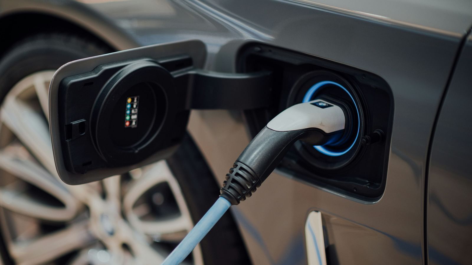 A car getting charged with an adapter while being stationary - The Cindrella Hotel, Siliguri