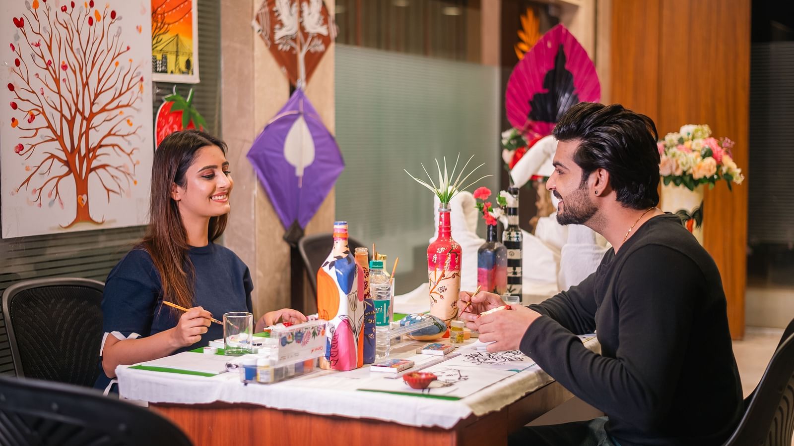  Guests sharing a light moment during a painting session at The Grand Legacy Resort and Spa.