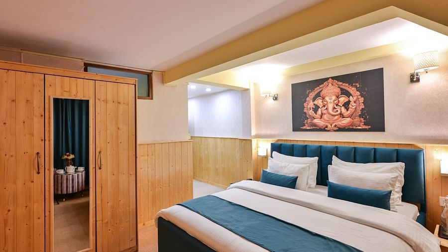 Deluxe Room with spacious bed, wooden furniture and warm lighitng at Avianna Seven Seas, Darjeeling11