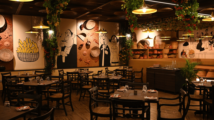 Fisherman's Wharf with several sets of tables and chairs and the walls painted with doodles at Essentia Premier Hotel, Chennai, one of the best places in Chennai for team outings