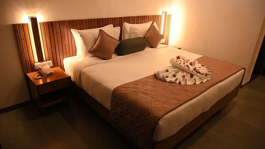 Side view of Two swans made of towels and decorated with flowers at the Kutumbh Suite at Mango Leaf Lake Resort, Pune